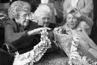 Katherine Ganter/Reporter Newspapers Lu Harrison folds up a blanket after a portrait photo shoot at Evergreen Hospice on May 8. Harrison was among several residents from Madison House who made and delivered fleece blankets to Evergreen Hospice.