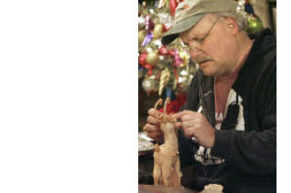 Dennis Brown at work in his  downtown shop last December.