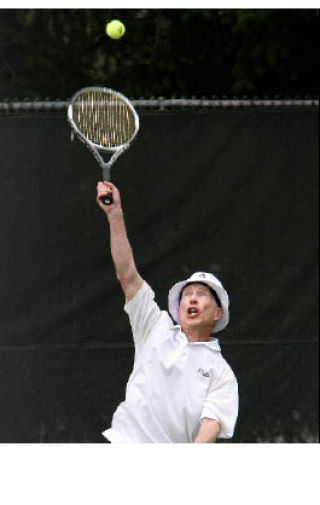 Virgil Morgan leaps up to return the ball during a singles match with Takshi Numoto at the Pacific NW USTA playoffs at Central Park Tennis Club on June 21. More than 300 players from around the region traveled to Kirkland for the event.