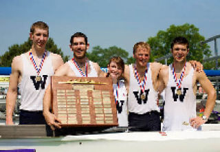 The University of Washington varsity four group receives their medals and holds the championship trophy after narrowly beating Marist College of New York to take the national title. The race was at Cherry Hill