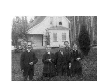 French family in front of home
