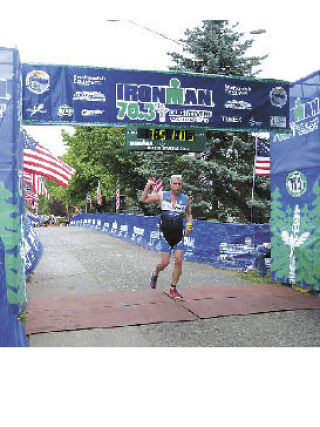 Sean Minister comes across the finish line at the Lake Stevens Half Ironman triathlon on July 6 this year. A half Ironman race is 70.3 miles long