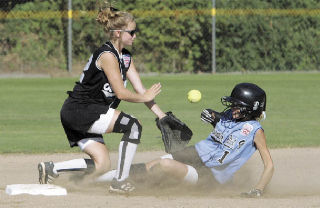 Washington’s Dani Faist (No. 1) slides safely into second base as Caitlin Herbet (No. 12) blocks the base during a game against the Southwest team from West Ouachita