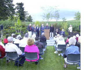 Dr. Bob Webb addresses a crowd of more than 100 in Heritage Hall’s new Centennial Garden. Representing the Rotary Club of Kirkland