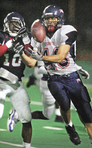 Juanita’s No. 43 pulls in a long pass ahead of Lindbergh’s Willie Creear to set up a touchdown in the first half at Renton Stadium Friday.