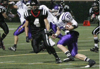 Lake Washington quarterback Erik Folkers (No. 5) carries the ball during a game at Memorial Stadium in Seattle on Fri.