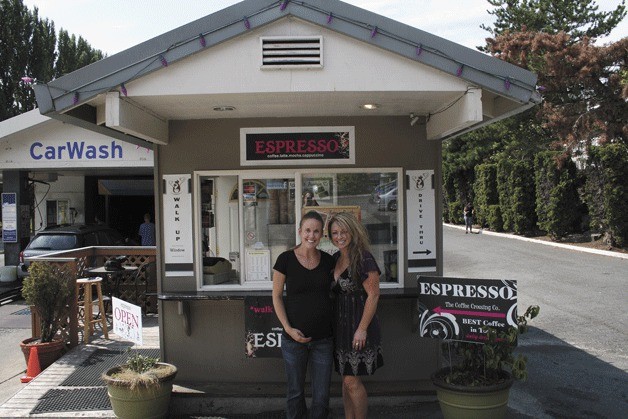 Coffee Crossing owner Brandee Krumbah (right) stands with a barista at their drive-thru coffee stand on 324 Central Way in downtown Kirkland. The coffee stand is expected to close on Sept. 3.