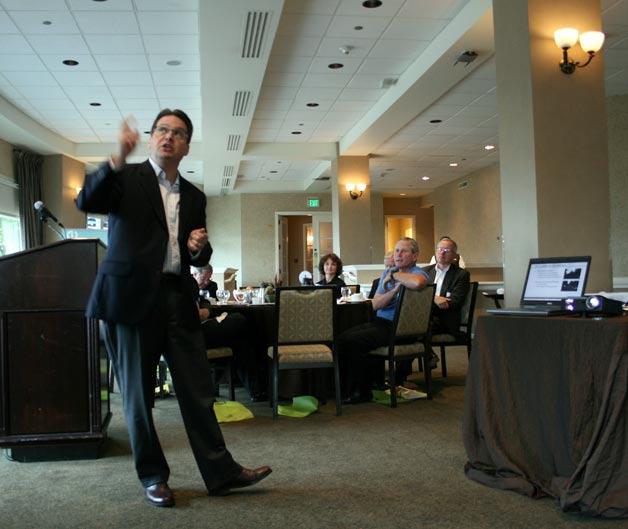 Andy Wappler delivers a gloomy weather forecast - and some jokes - to the Kirkland Chamber of Commerce on Tuesday at The Woodmark Hotel.