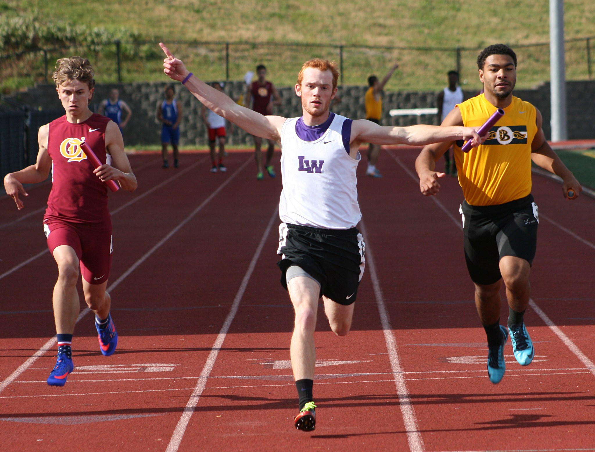 Lake Washington’s Scoutt Callens raises his arms in victory following the Kangaroos’ first-place finish in the 4x400 meter relay finals on Friday