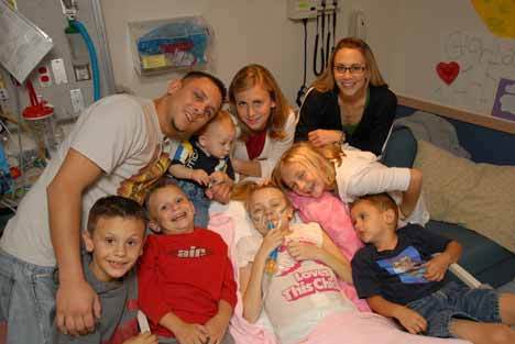 The Strauss family surrounds Gloria in the hospital. The 11-year-old passed away in September 2007 after a nearly five-year battle with cancer.