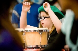 Discovery Community School student Ashley Pederson keeps the beat during the poetry cafe March 25.