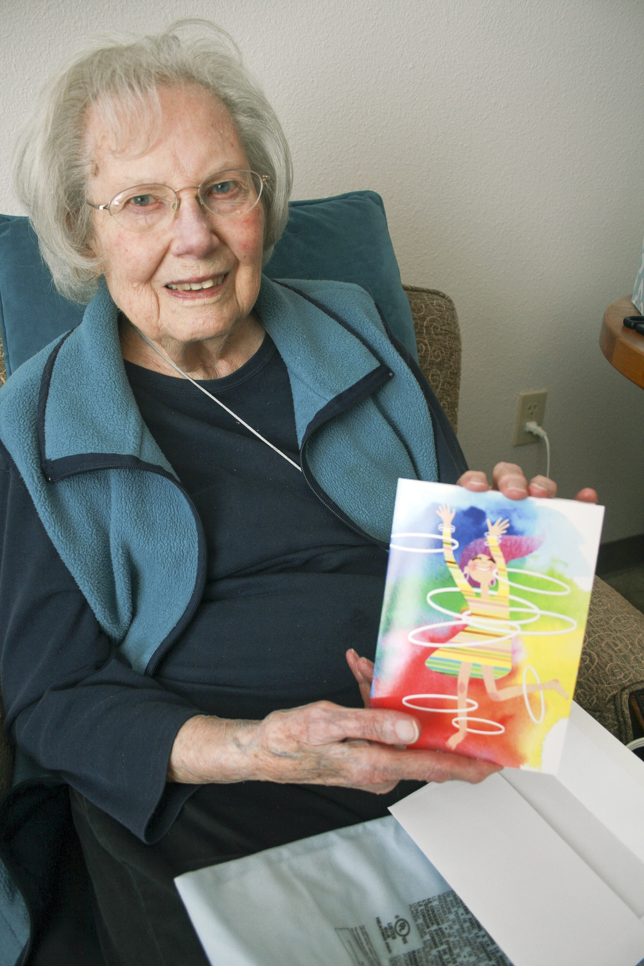 Alyce Ruttkay holds a birthday card in her room at Brookdale Senior Living on Monday