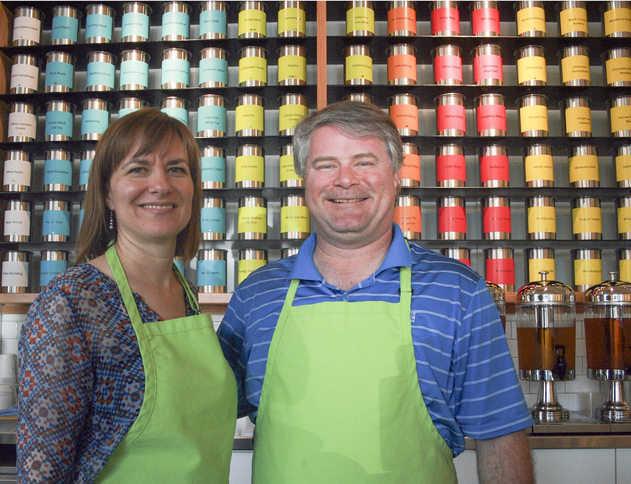 Amy and Will Riffle stand in front of their impressive worldwide collection of teas at their shop