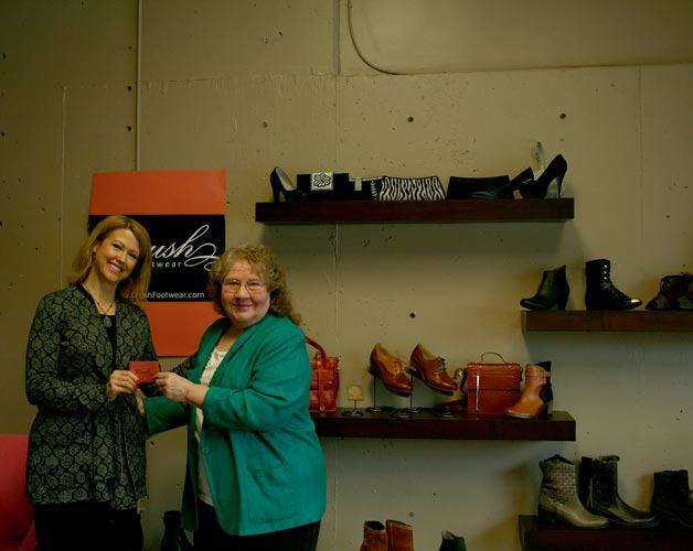 Beverly Fox was the winner in the Reporter’s recent Valentine’s contest drawing. Reporter sales representative Janeen Archer (left) presents Fox with a $150 gift card to Crush Footwear in Kirkland.