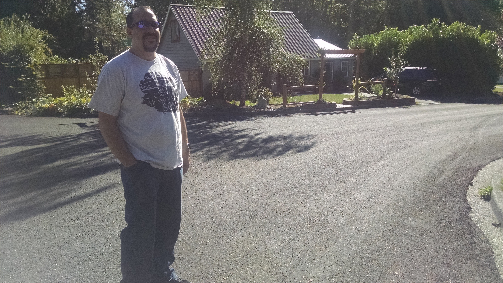 Finn Hill resident Matthew Saavedra stands at the corner of NE 142nd Place and 79th Avenue NE while talking about his slurry seal concerns on Sept. 9.