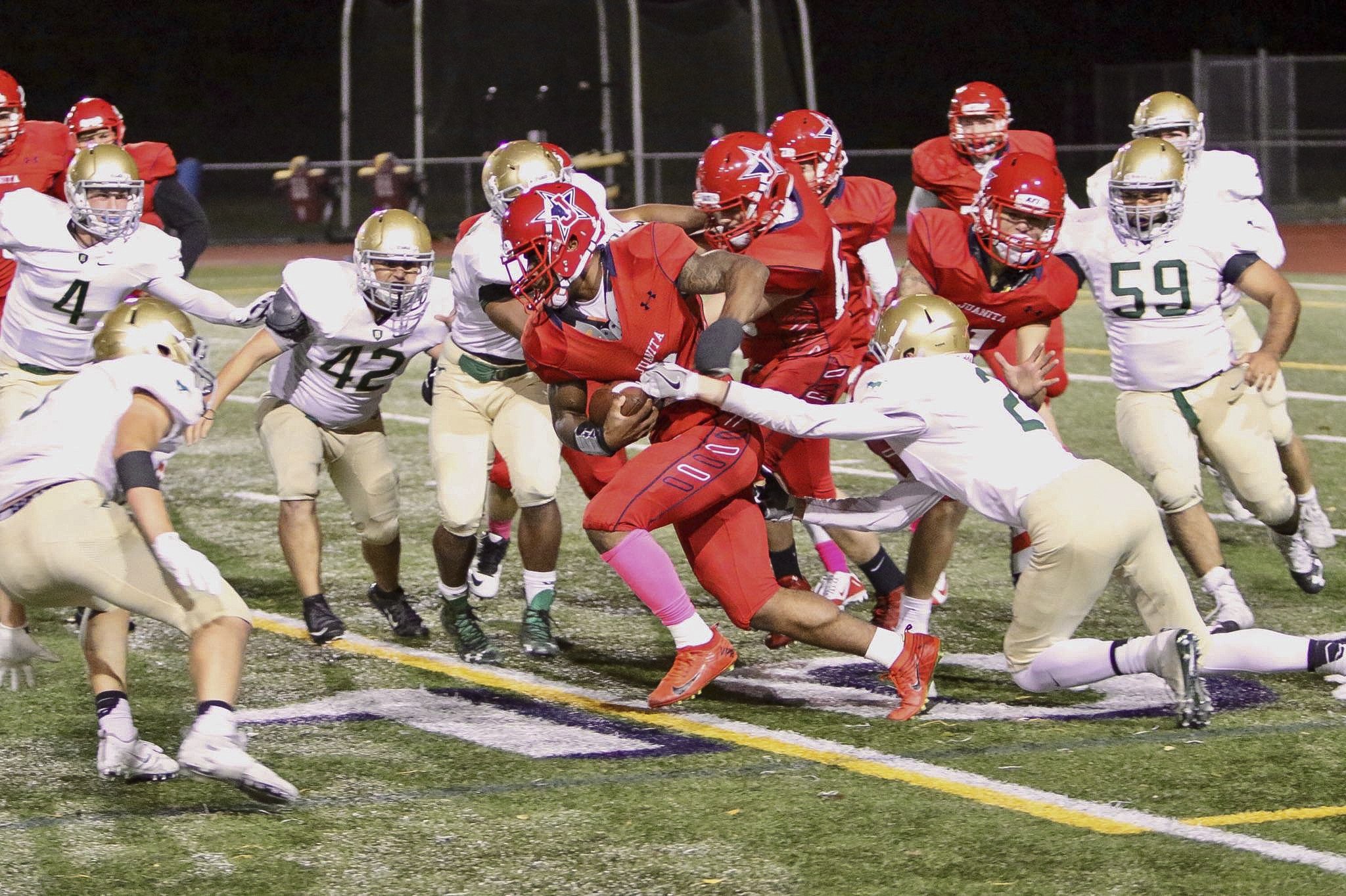 Juanita running back Salvon Ahmed drags a Redmond defender during the Rebels' 36-3 win on Friday at Bergh Field in Kirkland. Ahmed rushed for 264 yards and scored four touchdowns. Photo courtesy of Joe Byrne.
