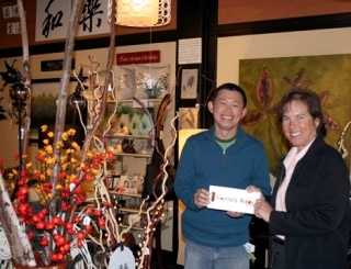 Simplicity Decor store owner A Liengboonlertchai presents Hopelink Business and Foundations Relations Manager Sandy Clark