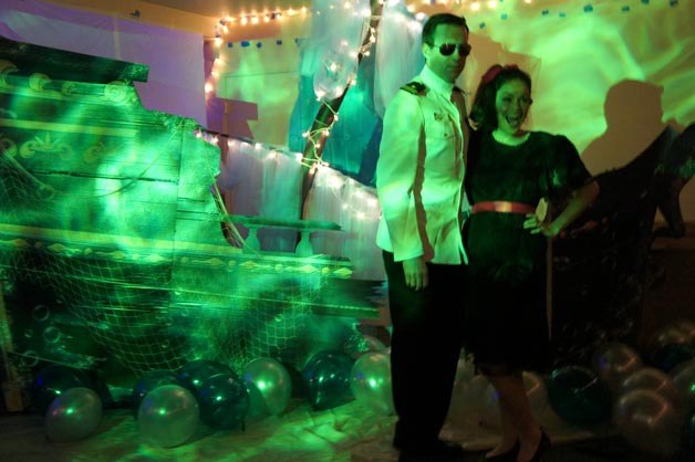 Jessica and Tom Kelly smile for a photo during an '80s-style 'prom night' at the Eagles Club in downtown Kirkland on Saturday. Dozens of Peter Kirk Elementary parents organized the adult prom