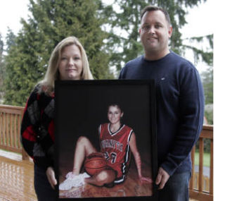 Vanessa White and husband Jeff display a photo of Chantel Still