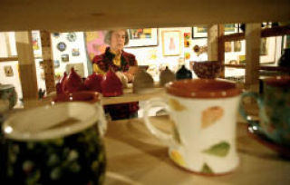 Maria Balicka looks at a piece of art during the Kirkland Arts Center’s Holiday Art Sale on Sat.