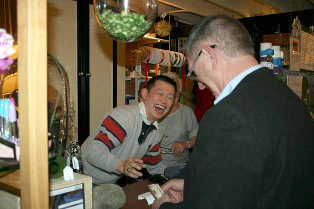 Simplicity Decor owner A. Suraphong shares a laugh with a customer on Wednesday afternoon