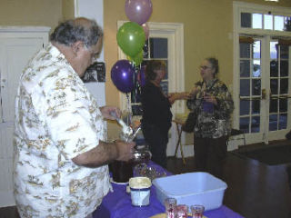 Vic Newhard helps himself to a serving of vanilla ice cream and blackberries he picked himself in Crestwoods Park. Kirkland Heritage Society member Barbara Loomis and Katherine Lindquist are chatting nearby. The social was held at Heritage Hall on Aug. 27.