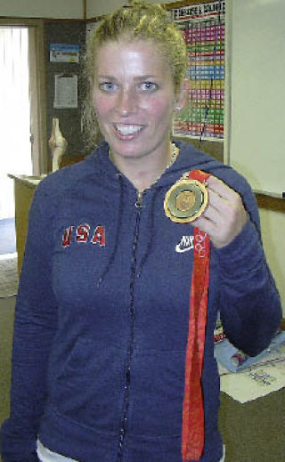 Kirkland native Jill Kintner holds up her bronze medal she recently won at this summer’s Olympic Games during a visit to Juanita High School. She was also honored the same week by the Kirkland City Council as a “Hometown Hero.”