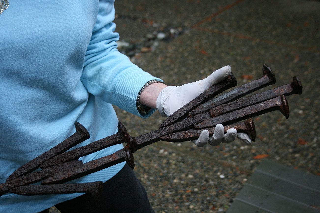 Merrily Dicks holds a sample of “The Spikes” sculpture that is displayed in her Kirkland backyard. One of her assistants, Yancy McCoy, helped create this piece. The full sculpture has been installed on the Cross Kirkland Corridor. CATHERINE KRUMMEY/Kirkland Reporter