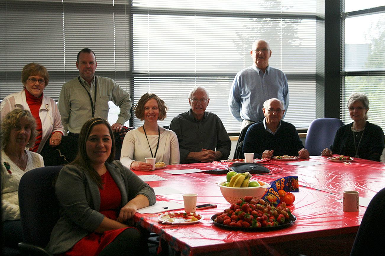 Kirkland City Hall front desk volunteers and staff, along with Volunteer Coordinator Patrick Tefft (standing, second from left), gather for an end-of-year appreciation breakfast. CATHERINE KRUMMEY/Kirkland Reporter