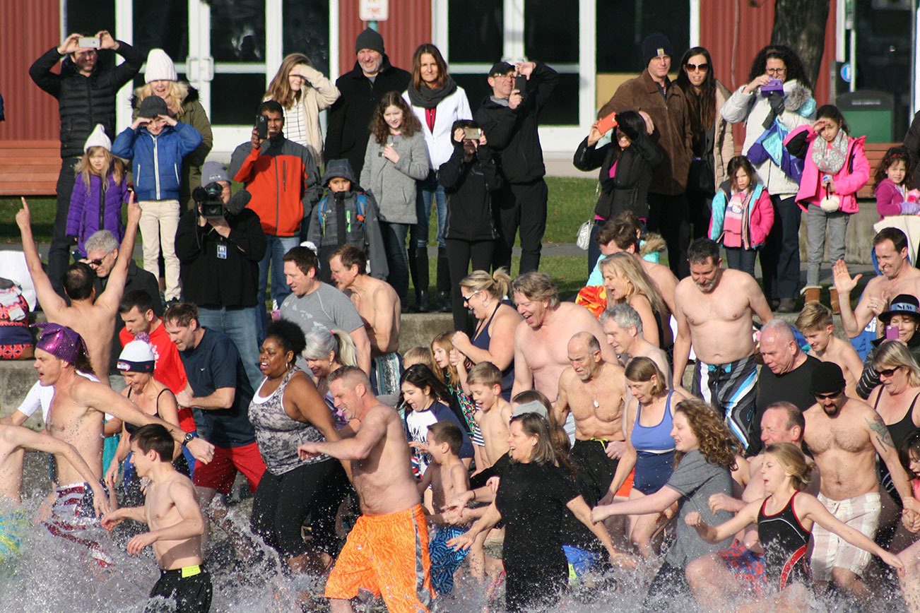 Polar Bear Plunge participants enter Lake Washington at Marina Park in Kirkland. CATHERINE KRUMMEY/Kirkland Reporter