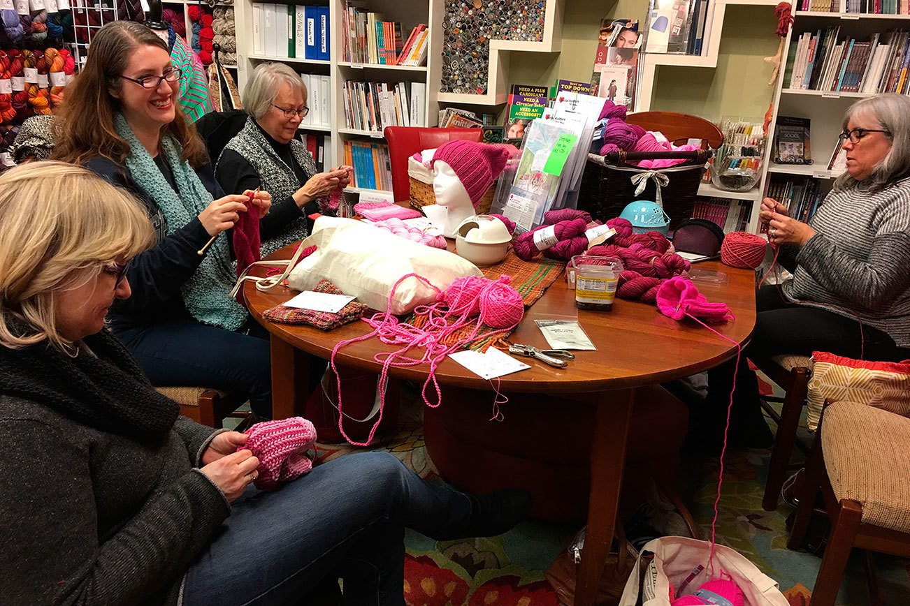 Debie Frable (left), Jennifer Cail, Susanna Gilbert and Sabrina Barton participate in a Pussyhat Project event at Serial Knitters in Kirkland. Contributed photo