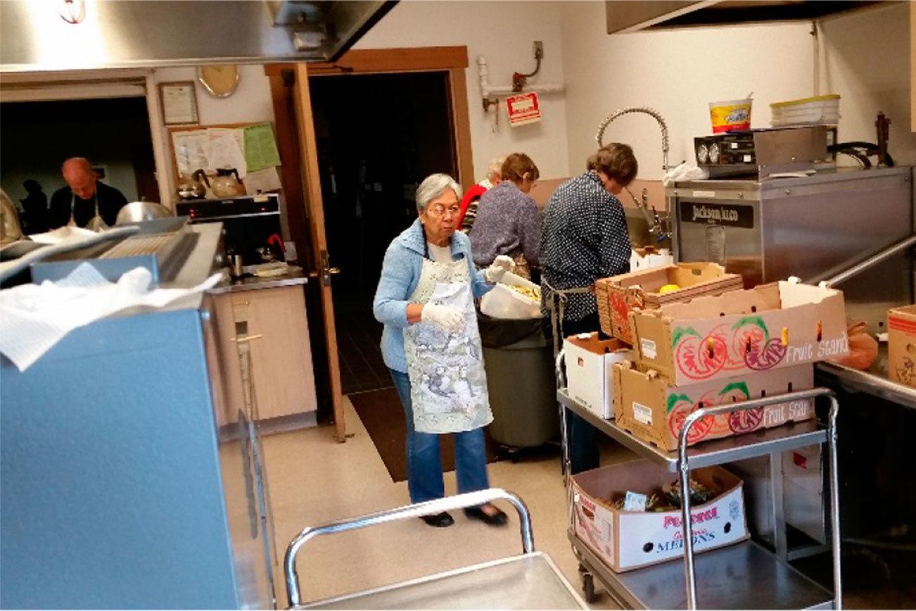 Volunteers prepare a meal for the St. Brendan Catholic Church’s SOS program. Contributed photo