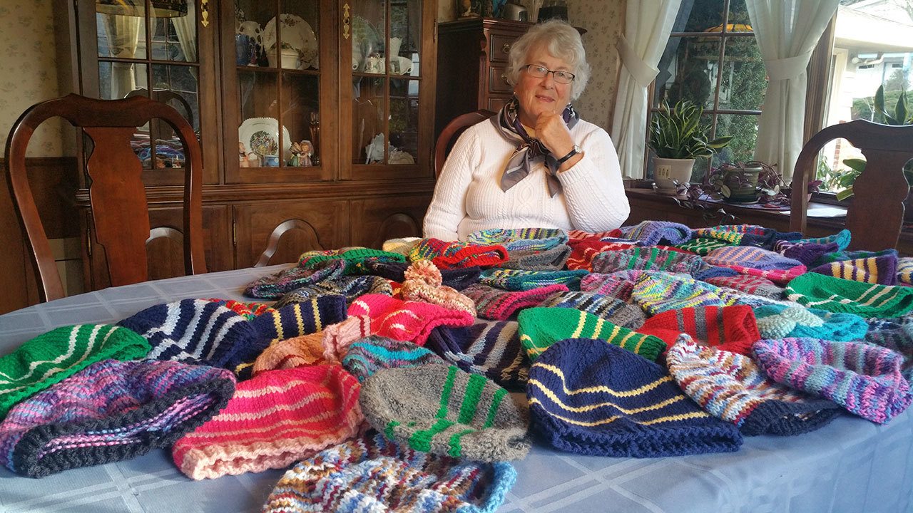 Molly Michener with some of the hats she knitted for Syrian refugees. SUSAN FITZGERALD/Contributed photo