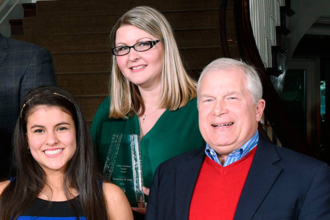 Samantha St. John, center, received the Teddy Overleese Community Service Award from the Kirkland Downtown Association earlier this year. She was recently named the executive director of the Greater Kirkland Chamber of Commerce. Reporter file photo