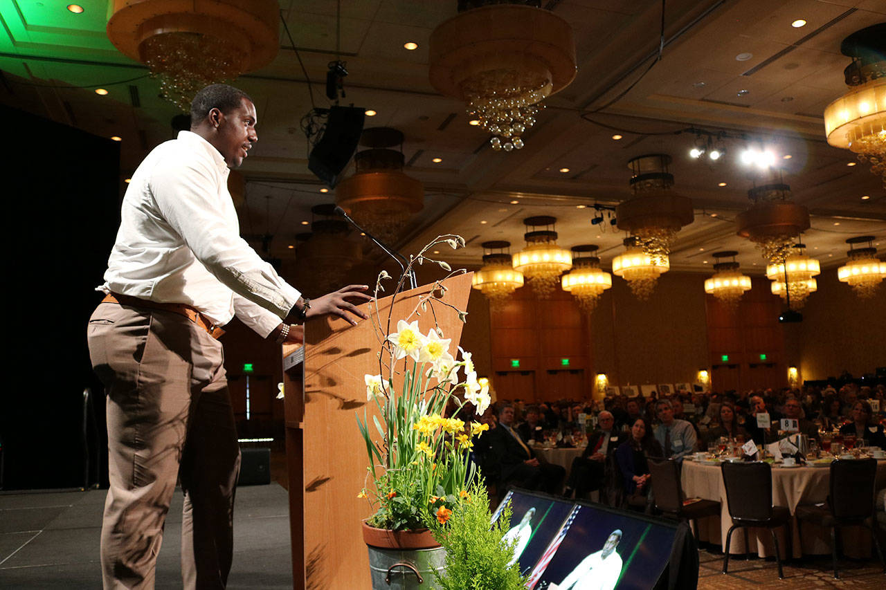 Seattle Seahawks defensive end Tylor Harris encourages Celebration of Youth luncheon attendees to contribute financially to support Friends of Youth. Samantha Pak, Redmond Reporter