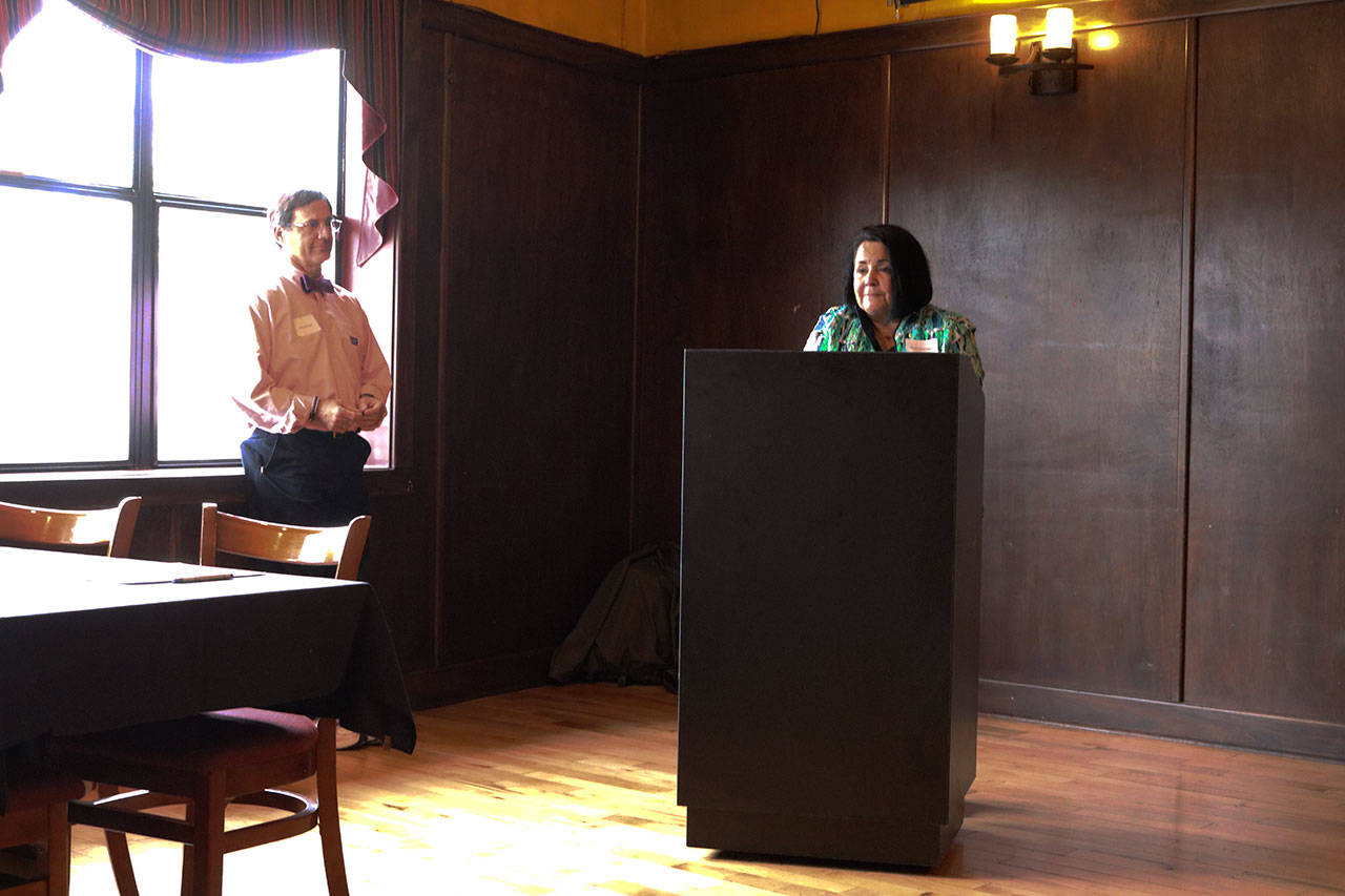 EvergreenHealth’s Rose Guerrero speaks during an American Cancer Society event at Wilde Rover as emcee by J.D. Drollinger looks on and listens. CATHERINE KRUMMEY / Kirkland Reporter