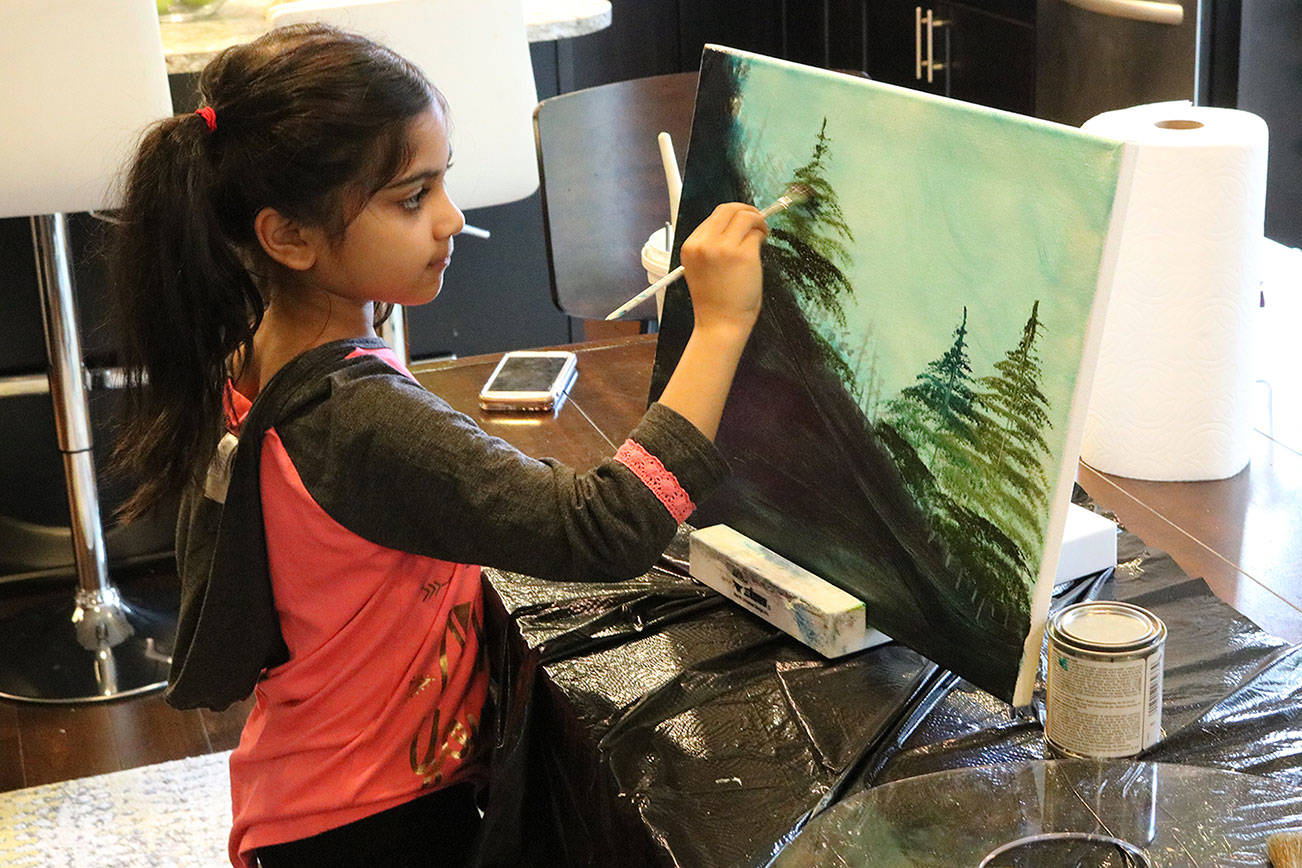 Ira Ganjikunta, 6, works on a painting at her Redmond home. CATHERINE KRUMMEY/Kirkland Reporter