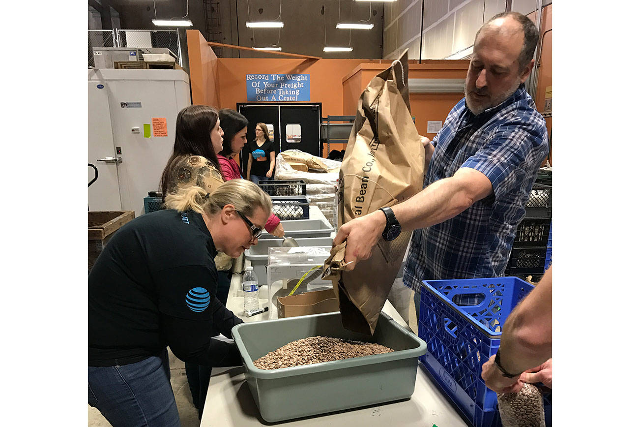 AT&T employees, from left, Kristin Burrows and Roger Jochim donate their time at Hopelink in Kirkland. Contributed photo