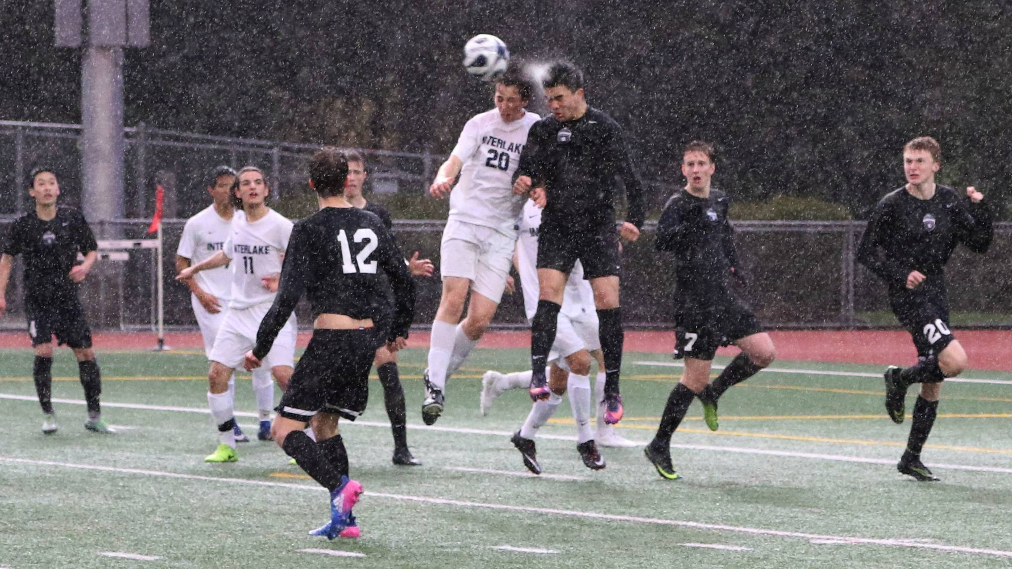 Lake Washington’s Edgar Iniguez (third from right) goes up for a header in the rain against Interlake. Courtesy of Doug Lewis