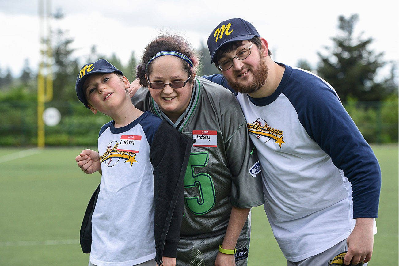 Lindsey and Erik, right, use to be Miracle League kids, but now that they’re grown up they come as helpers with the younger kids such as Liam, left. Contributed photo/Chris Rusnak
