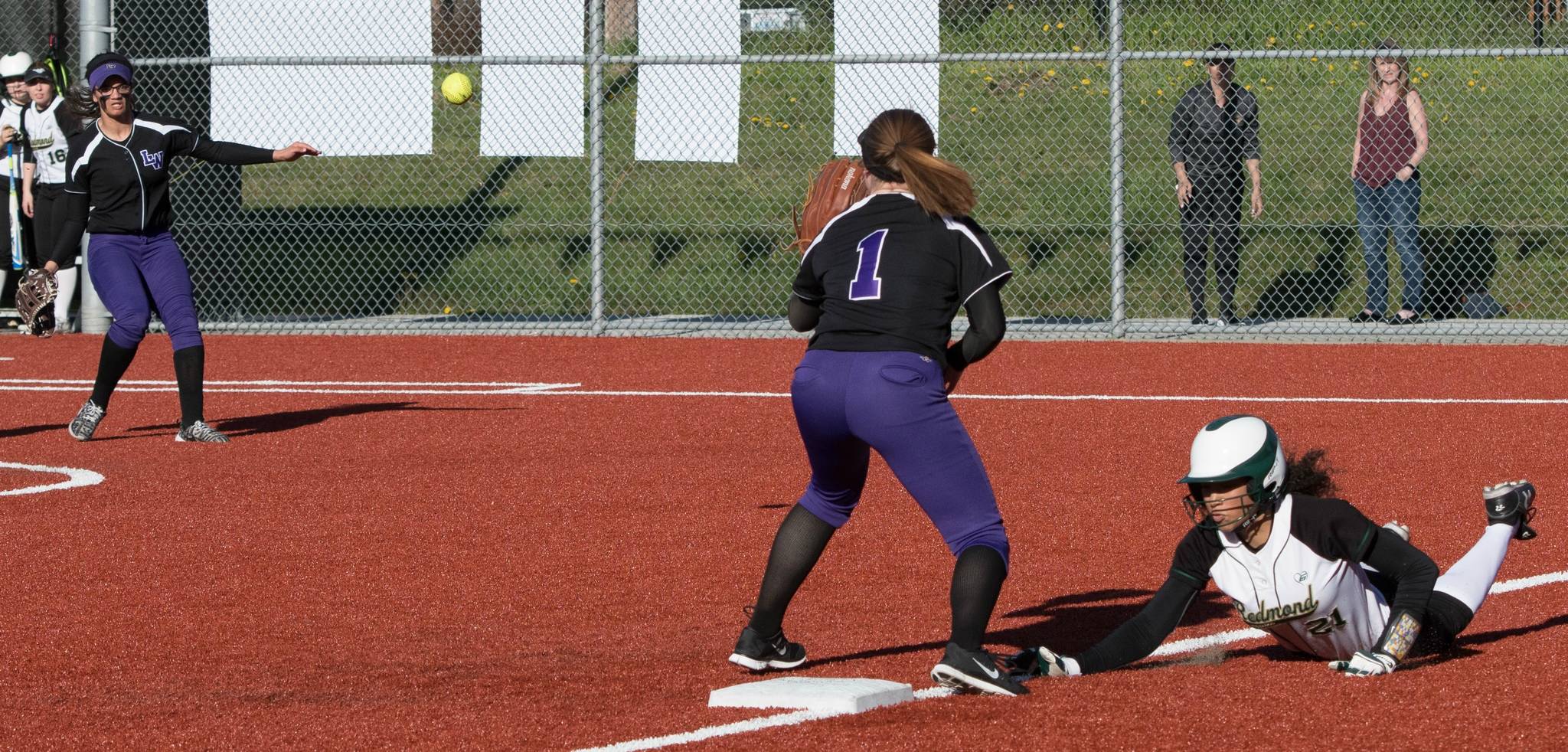 Lake Washington players try to put out a Redmond runner. Courtesy of Eric Chen