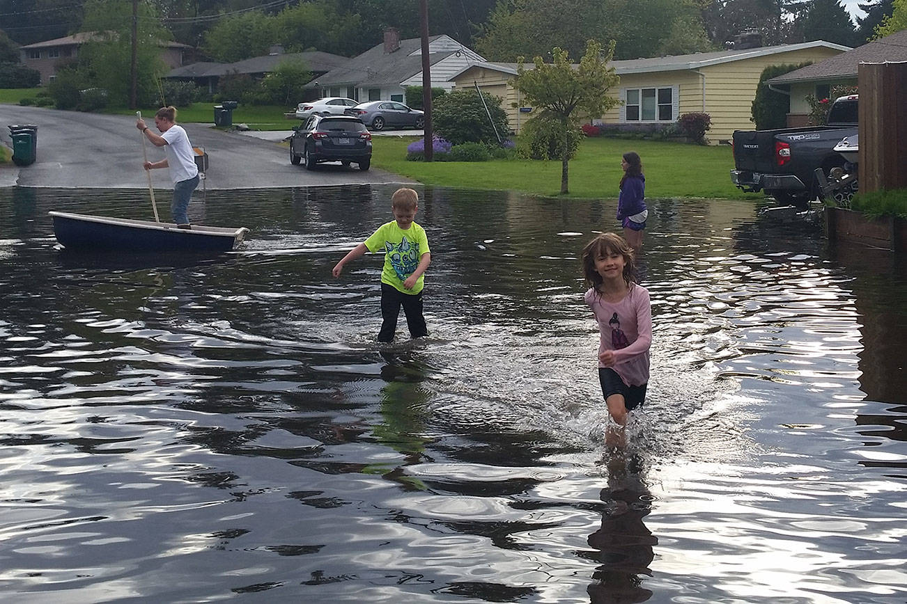 Local residents check out the water buildup near the intersection of 145th Street and 75th Avenue at the Kirkland-Kenmore boundary. Contributed photo