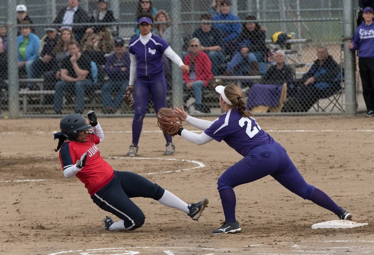 Juanita’s Sasha Mitchell is thrown out advancing to second on Friday. Lake Washington’s Anna Robinson is at second base and LW’s Marissa Ewald is in the background. LW won, 13-2, and was backed by homers by Jamie Pippin and Anna Robinson. Brynn Radke had three hits for Juanita. Courtesy of Eric Chen