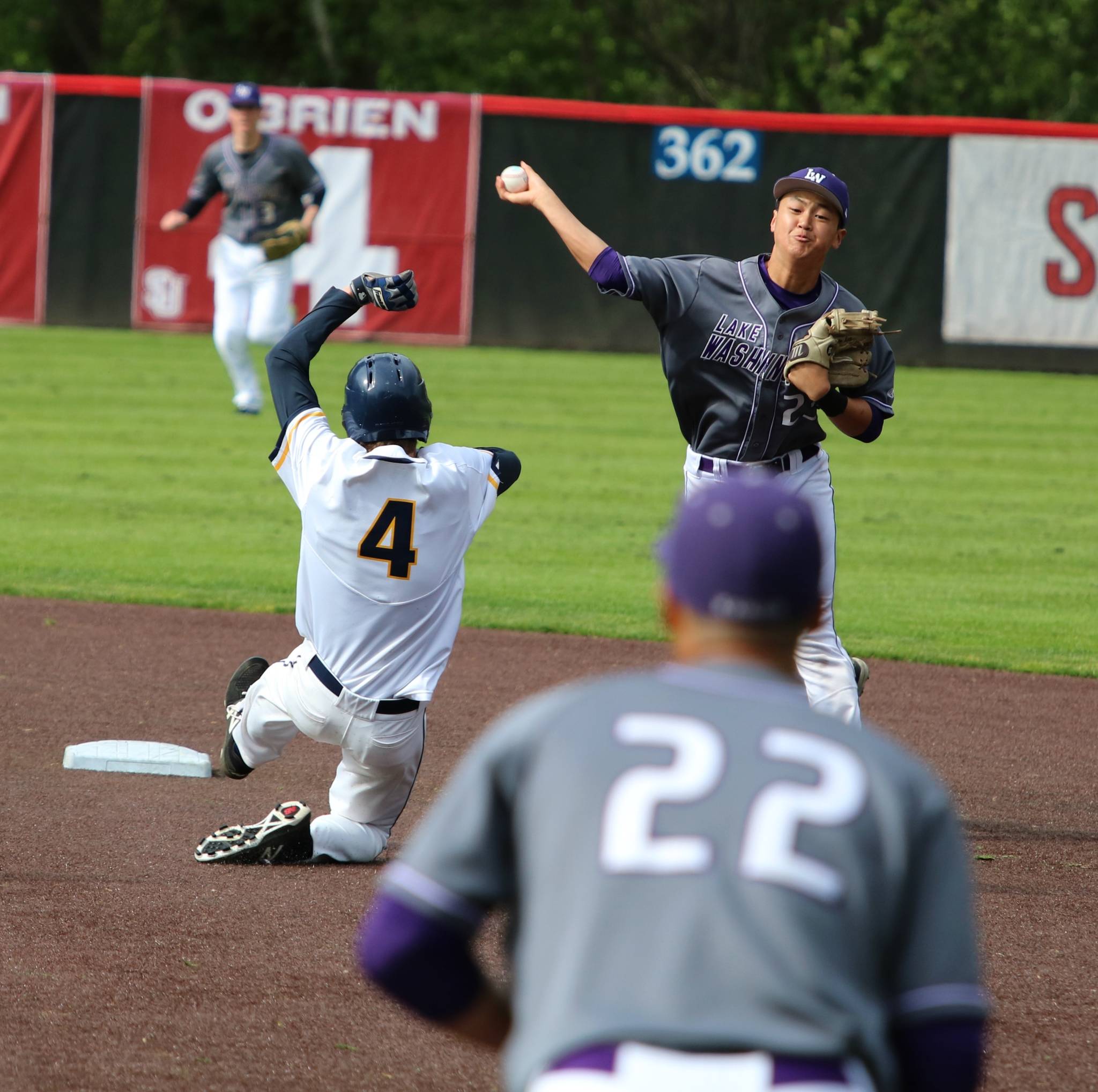 Lake Washington shortstop Travis Lee completes a double play on Friday. Andy Nystrom, Kirkland Reporter