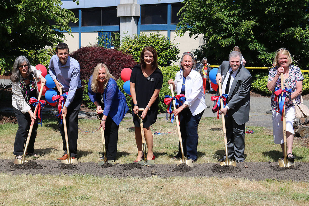 Lake Washington School District Board Vice President Siri Biesner, Kirkland City Councilmember Jon Pascal, LWSD Superintendent Dr. Traci Pierce, Kirkland Mayor Amy Walen, LWSD Board Member Nancy Bernard, LWSD Board Member Mark Stuart and City Councilmember Penny Sweet participate in a groundbreaking ceremony at Juanita High School. CATHERINE KRUMMEY / Kirkland Reporter