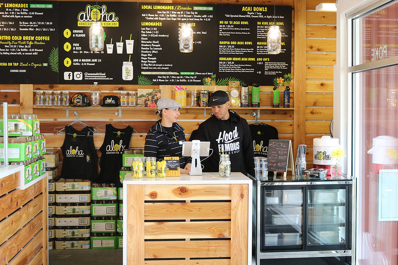 Kirkland Wow Wow Hawaiian Lemonade owners Julianne and Terrence Santos chat after helping some customers. CATHERINE KRUMMEY, Kirkland Reporter