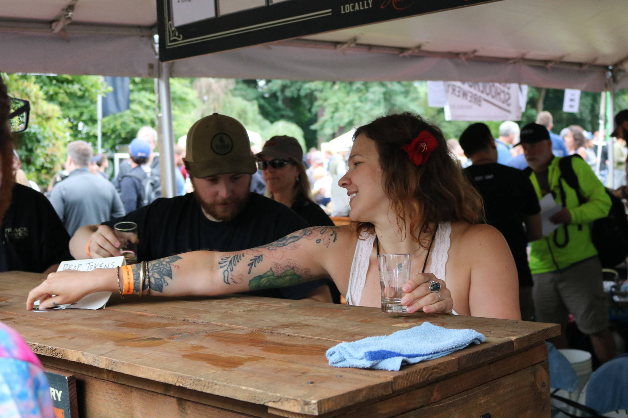 Karen Troy, taproom manager for Black Raven Brewing in Redmond, staffs the kiosk during last weekend’s Washington Brewers Festival at Marymoor Park. Aaron Kunkler, Reporter Newspapers