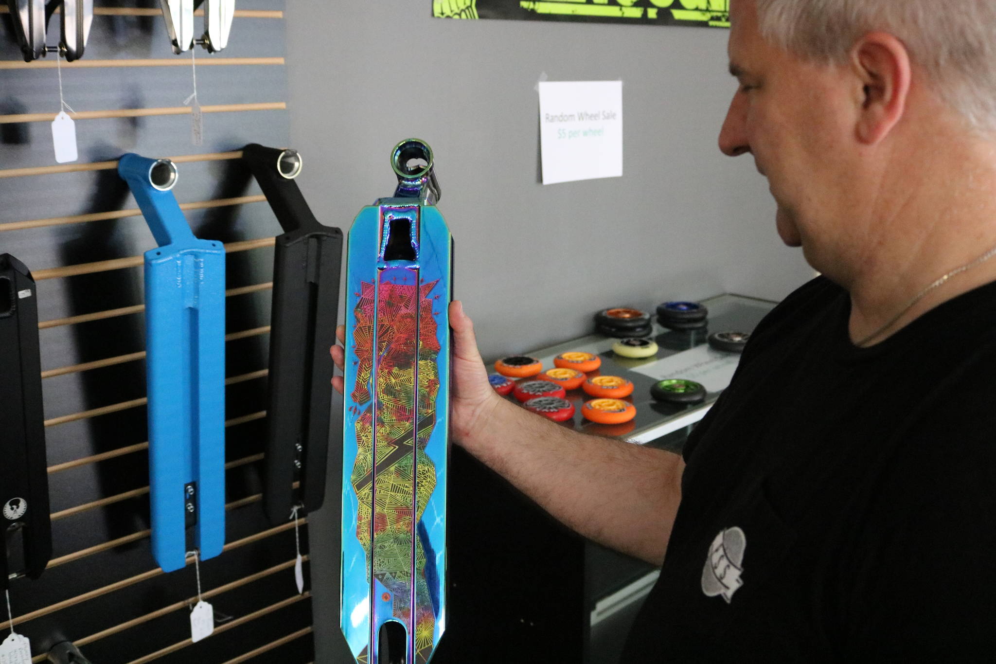 Pro Scooter Shop co-owner David Power shows one of his many scooter decks he has at his shop in Redmond. Aaron Kunkler, Reporter Newspapers