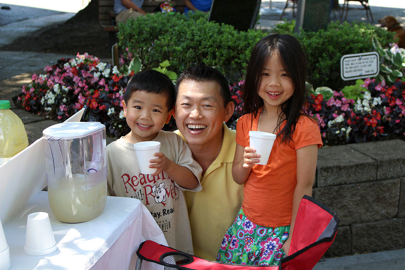 Suraphong “A” Liengboonlertchai, owner of Simplicity ABC and Simplicity Decor, checks in on Audrey and Elliott Ku during the 2013 Stand for a Cause program. Audrey and Elliott raised $68.50 that year for their charity, World Vision, which helps kids in poverty.