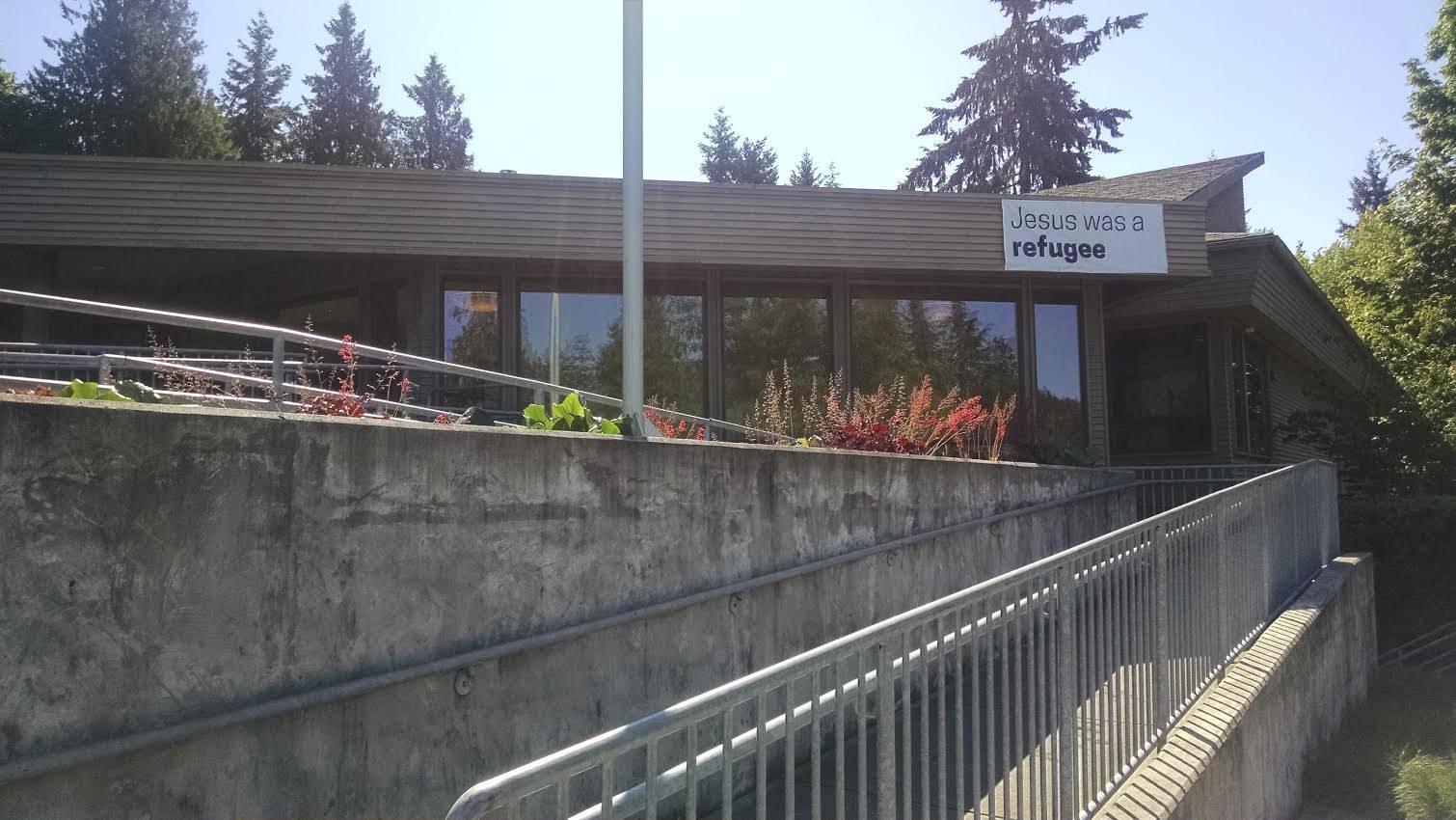 A banner on the outside of Holy Spirit Lutheran Church reads, “Jesus was a refugee.” The church has a committee in place to host refugees when they come to the United States. CATHERINE KRUMMEY, Kirkland Reporter